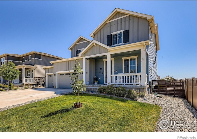 10 N Quantock St, Aurora, CO 80018 - view of front facade with board and batten siding, covered porch, an attached garage, and driveway