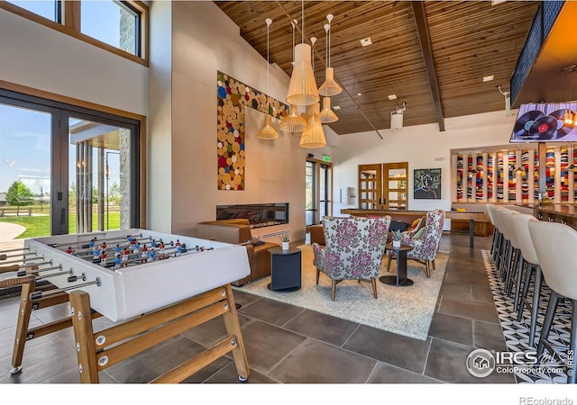 10 N Quantock St, Aurora, CO 80018 - playroom featuring a wood ceiling with exposed beams, high vaulted ceiling, and healthy amount of natural light