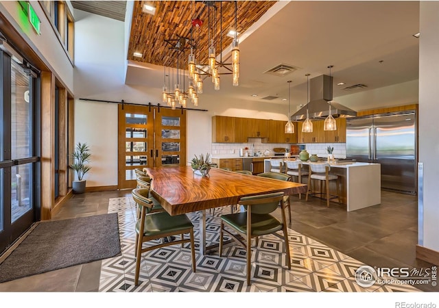 10 N Quantock St, Aurora, CO 80018 - dining space with a chandelier, tile patterned floors, french doors, and a high ceiling
