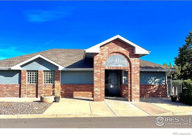 13560 Detroit St, Thornton, CO 80241 - view of front of home featuring brick siding and a shingled roof