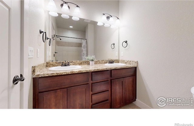 2107 Blackbird Dr, Fort Collins, CO 80525 - full bathroom featuring double vanity and tiled shower