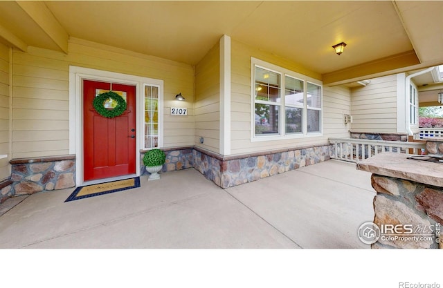 2107 Blackbird Dr, Fort Collins, CO 80525 - entrance to property featuring covered porch and stone siding