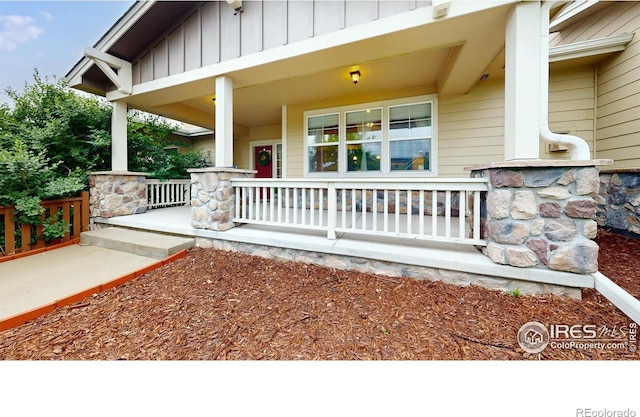 2107 Blackbird Dr, Fort Collins, CO 80525 - view of exterior entry with covered porch and board and batten siding