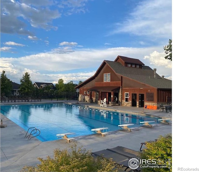 2107 Blackbird Dr, Fort Collins, CO 80525 - community pool featuring a diving board and a patio
