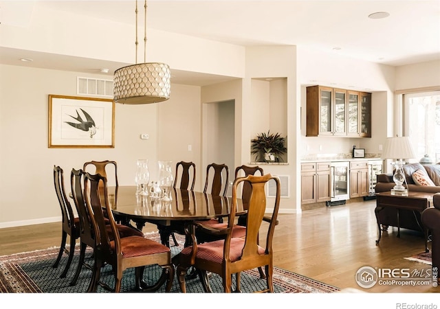 4993 Clubhouse Ct, Boulder, CO 80301 - dining area featuring wine cooler, wood finished floors, wet bar, baseboards, and recessed lighting