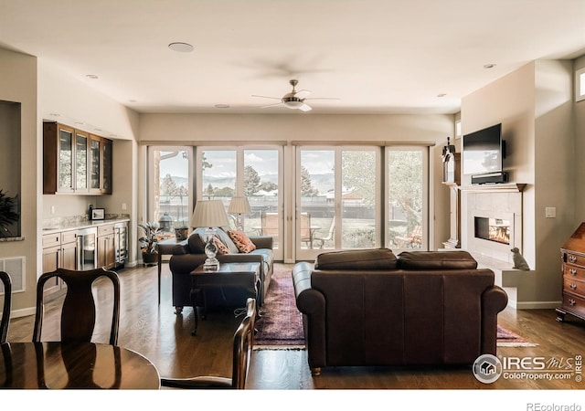 4993 Clubhouse Ct, Boulder, CO 80301 - living room with a ceiling fan, wood finished floors, a tile fireplace, baseboards, and wine cooler