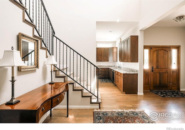 4993 Clubhouse Ct, Boulder, CO 80301 - entrance foyer featuring light wood-style floors, stairway, and baseboards