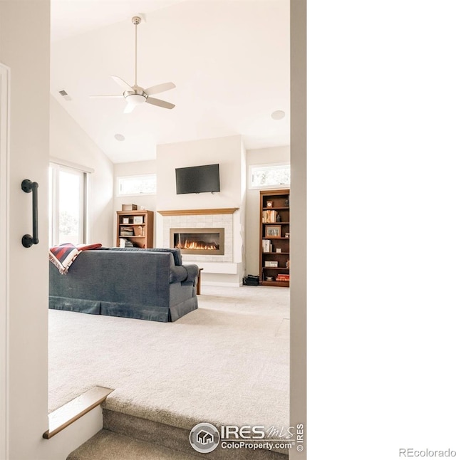 4993 Clubhouse Ct, Boulder, CO 80301 - carpeted living area featuring a tiled fireplace, ceiling fan, and lofted ceiling