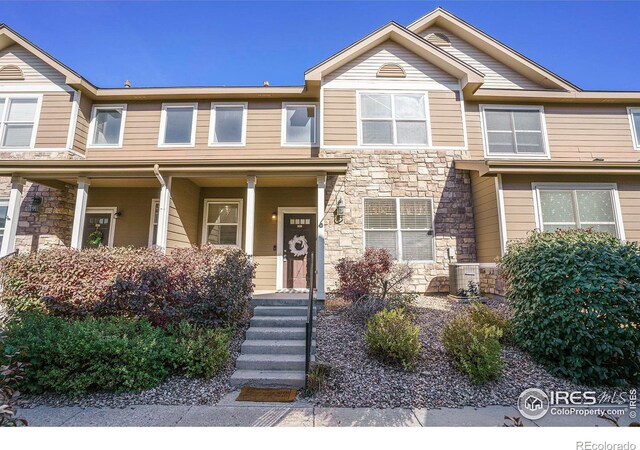 5551 29th St, Greeley, CO 80634 - view of property with stone siding and central AC