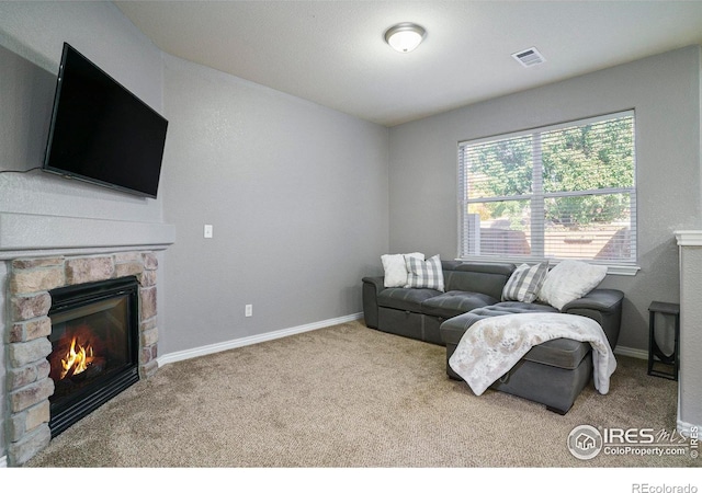 5551 29th St, Greeley, CO 80634 - living room featuring a stone fireplace, carpet, and baseboards