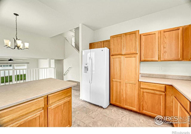 1711 101st Avenue Ct, Greeley, CO 80634 - kitchen featuring white fridge with ice dispenser, a chandelier, hanging light fixtures, a ceiling fan, and light countertops