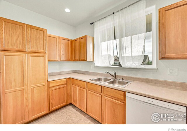 1711 101st Avenue Ct, Greeley, CO 80634 - kitchen with dishwasher, a sink, light countertops, light marble finish flooring, and recessed lighting