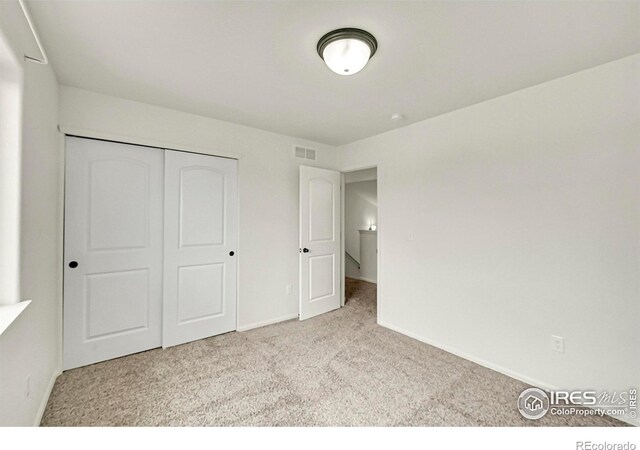 1711 101st Avenue Ct, Greeley, CO 80634 - unfurnished bedroom featuring carpet floors, baseboards, and a closet