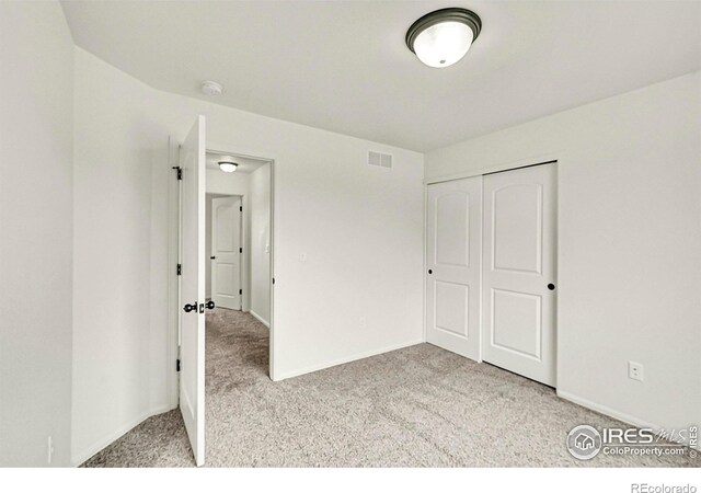 1711 101st Avenue Ct, Greeley, CO 80634 - unfurnished bedroom with carpet flooring, baseboards, and a closet