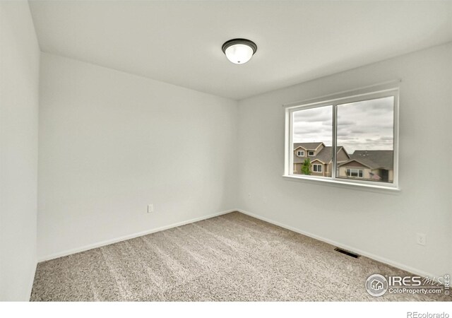 1711 101st Avenue Ct, Greeley, CO 80634 - carpeted spare room featuring baseboards