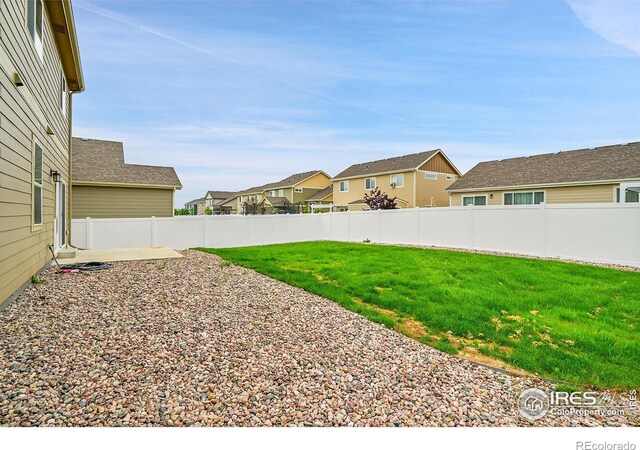 1711 101st Avenue Ct, Greeley, CO 80634 - view of yard with a residential view and a patio