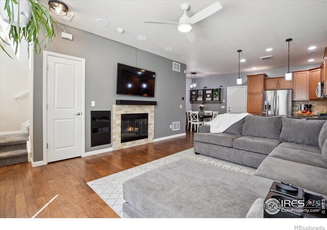16031 W 63rd Ln W Unit D, Arvada, CO 80403 - living room with ceiling fan, wood-type flooring, baseboards, stairway, and a glass covered fireplace