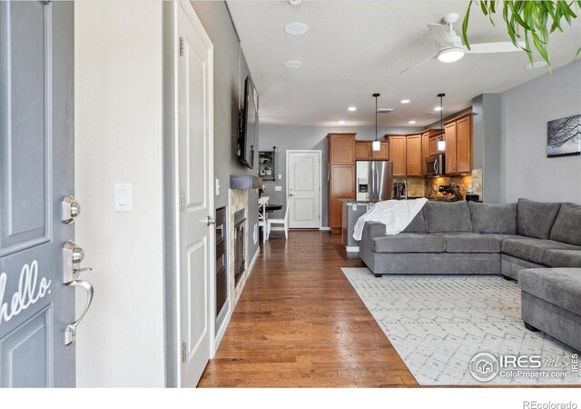 16031 W 63rd Ln W Unit D, Arvada, CO 80403 - living room with wood finished floors, recessed lighting, and a ceiling fan