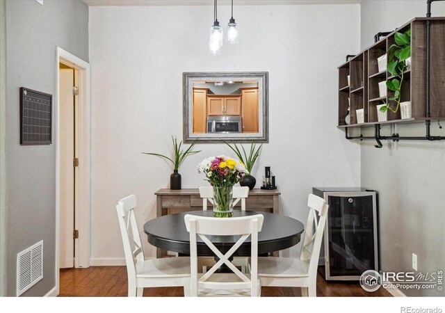 16031 W 63rd Ln W Unit D, Arvada, CO 80403 - dining area featuring wood finished floors, a heating unit, and baseboards