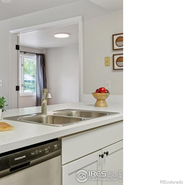800 Mohawk Dr, Boulder, CO 80303 - kitchen with stainless steel dishwasher, a sink, light countertops, and white cabinetry