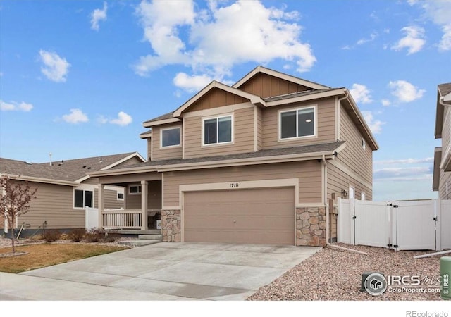 1718 101st Avenue Ct, Greeley, CO 80634 - craftsman-style home with covered porch, a gate, a garage, board and batten siding, and driveway