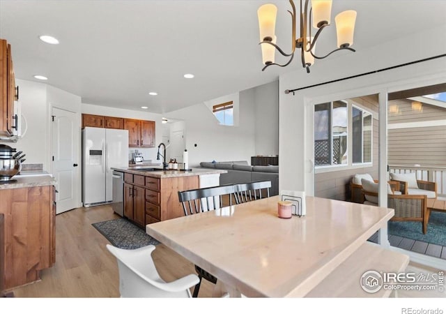 1718 101st Avenue Ct, Greeley, CO 80634 - dining room featuring light wood-style flooring, recessed lighting, and a chandelier