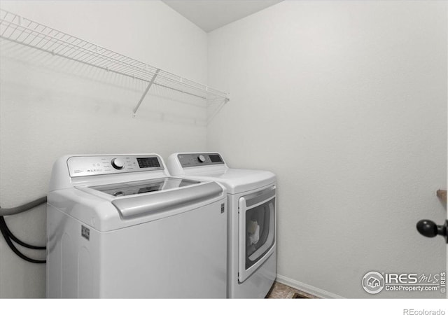 1718 101st Avenue Ct, Greeley, CO 80634 - laundry area with washer and dryer and baseboards