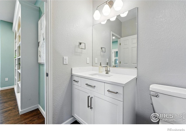 2133 Indian Peaks Cir, Longmont, CO 80504 - bathroom featuring wood finished floors, vanity, and a textured wall