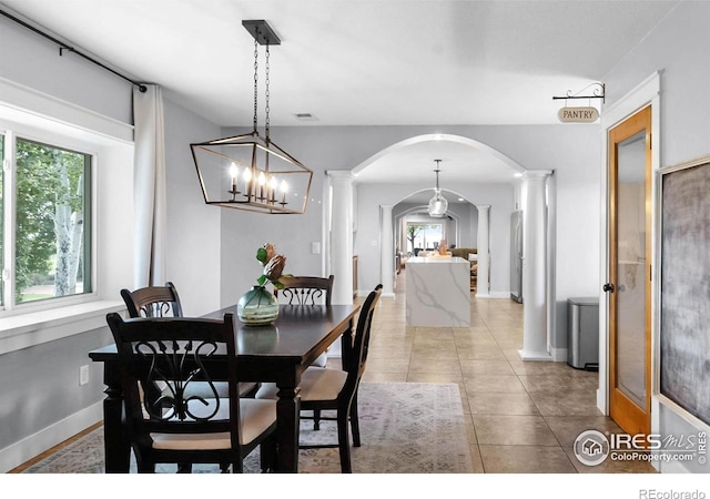 9139 County Road 54, Milliken, CO 80543 - dining room with arched walkways, ornate columns, and healthy amount of natural light