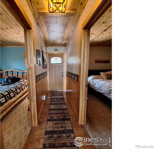 56 Pamlico Ct, Red Feather Lakes, CO 80545 - corridor featuring wainscoting, wallpapered walls, wood finished floors, and wood walls