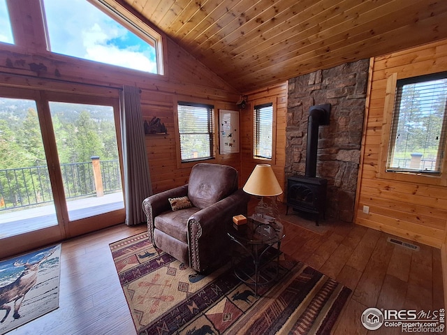 56 Pamlico Ct, Red Feather Lakes, CO 80545 - sitting room with vaulted ceiling, hardwood / wood-style floors, wooden walls, wooden ceiling, and a wood stove