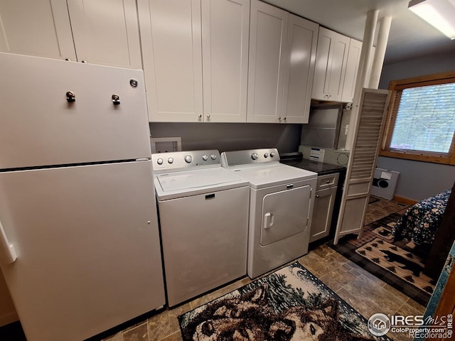 56 Pamlico Ct, Red Feather Lakes, CO 80545 - laundry room with cabinet space, washing machine and dryer, and dark stone finish flooring