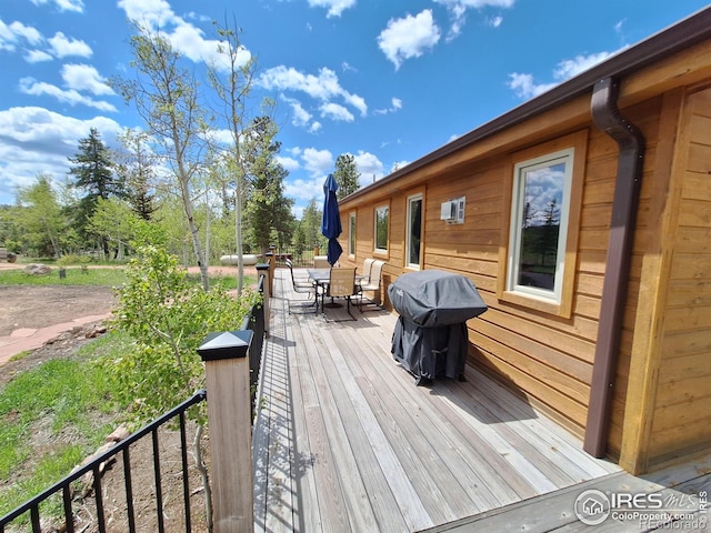 56 Pamlico Ct, Red Feather Lakes, CO 80545 - wooden deck with outdoor dining space and a grill
