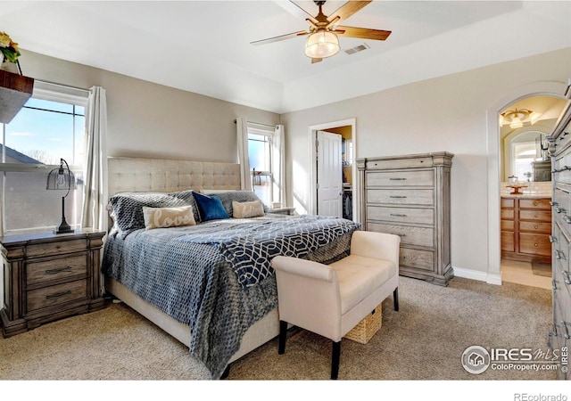 5895 E Conservation Dr, Frederick, CO 80504 - bedroom featuring light colored carpet, arched walkways, a ceiling fan, and connected bathroom