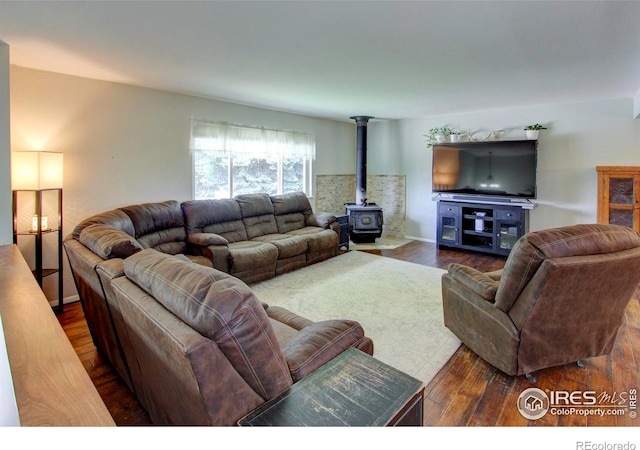204 35th St SW, Loveland, CO 80537 - living area with a wood stove and dark wood finished floors