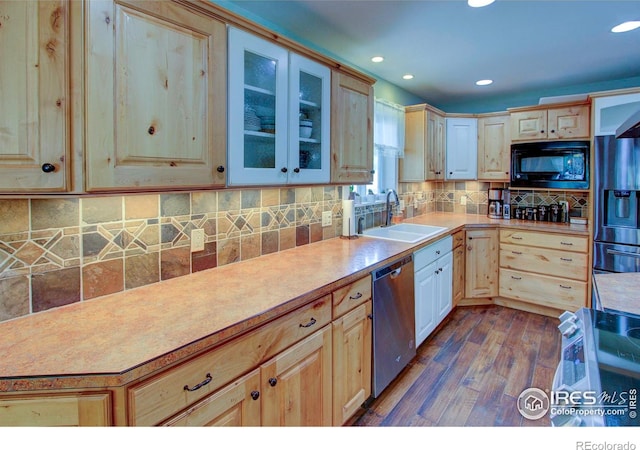 204 35th St SW, Loveland, CO 80537 - kitchen with black microwave, stainless steel dishwasher, a sink, refrigerator with ice dispenser, and dark wood-style flooring