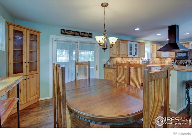 204 35th St SW, Loveland, CO 80537 - dining space with a chandelier, dark wood-style flooring, recessed lighting, and baseboards