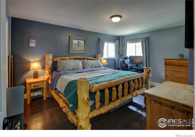 204 35th St SW, Loveland, CO 80537 - bedroom featuring dark wood-style flooring and baseboards