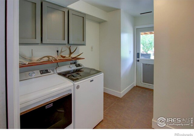 204 35th St SW, Loveland, CO 80537 - washroom with washing machine and clothes dryer, cabinet space, light tile patterned flooring, and baseboards