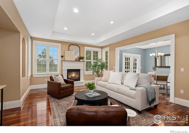1926 Crested Butte Ct, Loveland, CO 80538 - living area featuring dark wood-style flooring, a chandelier, baseboards, a glass covered fireplace, and recessed lighting