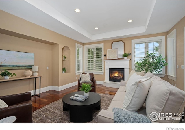 1926 Crested Butte Ct, Loveland, CO 80538 - living area with wood finished floors, a glass covered fireplace, baseboards, recessed lighting, and a raised ceiling