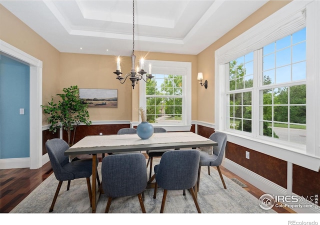1926 Crested Butte Ct, Loveland, CO 80538 - dining room featuring a chandelier, a raised ceiling, wood finished floors, and baseboards