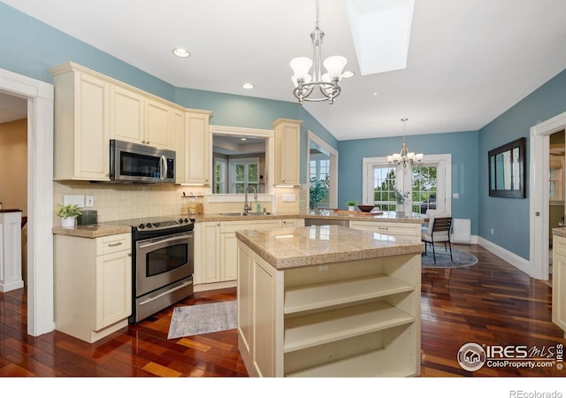 1926 Crested Butte Ct, Loveland, CO 80538 - kitchen featuring appliances with stainless steel finishes, a chandelier, a sink, dark wood-style floors, and tasteful backsplash
