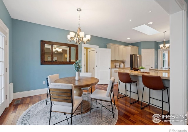 1926 Crested Butte Ct, Loveland, CO 80538 - dining room featuring a chandelier, baseboards, hardwood / wood-style flooring, a skylight, and recessed lighting