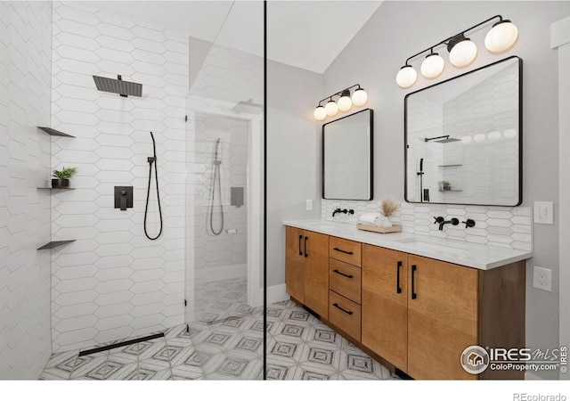 1926 Crested Butte Ct, Loveland, CO 80538 - bathroom with double vanity, a walk in shower, vaulted ceiling, and decorative backsplash