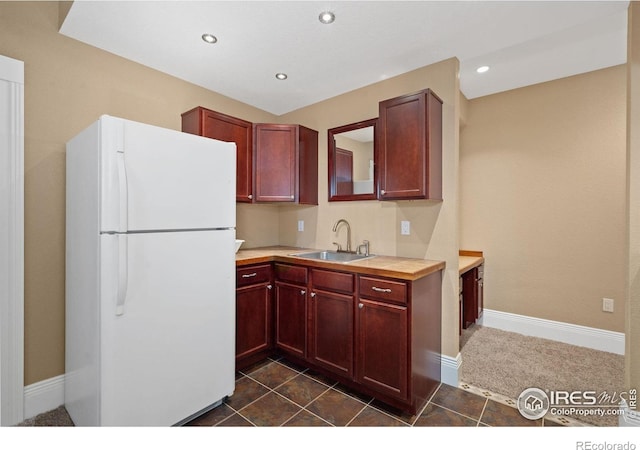1926 Crested Butte Ct, Loveland, CO 80538 - kitchen with freestanding refrigerator, a sink, recessed lighting, reddish brown cabinets, and baseboards