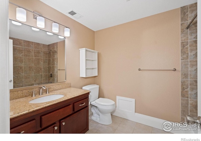 1926 Crested Butte Ct, Loveland, CO 80538 - bathroom with toilet, vanity, tile patterned flooring, baseboards, and a tile shower