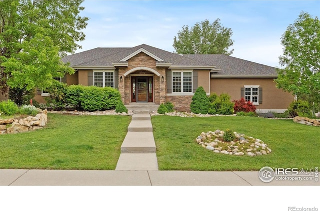 1926 Crested Butte Ct, Loveland, CO 80538 - view of front of house with a front lawn, stone siding, roof with shingles, and stucco siding