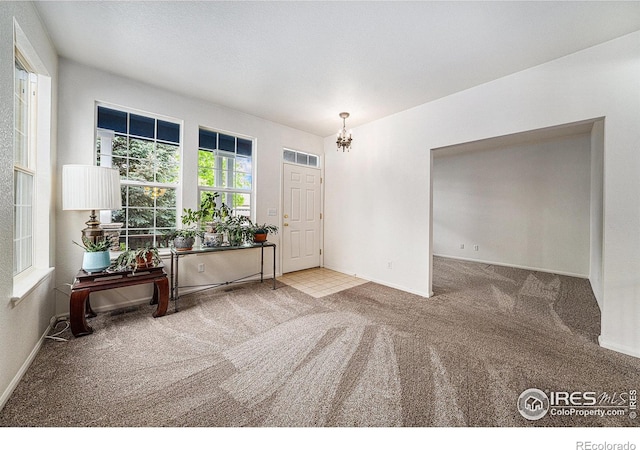 1874 Ute Creek Dr, Longmont, CO 80504 - carpeted foyer entrance with a chandelier and baseboards