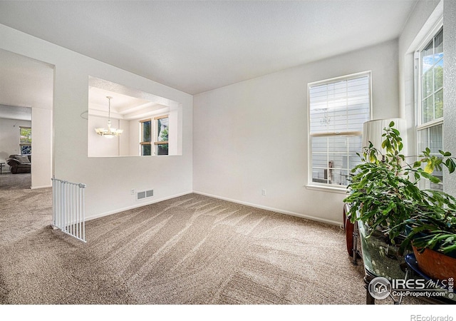 1874 Ute Creek Dr, Longmont, CO 80504 - carpeted empty room with a chandelier and baseboards